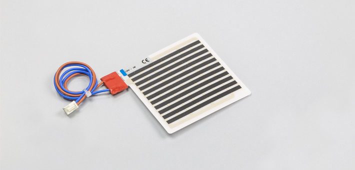 Polyester film heater terminated outside the heating area