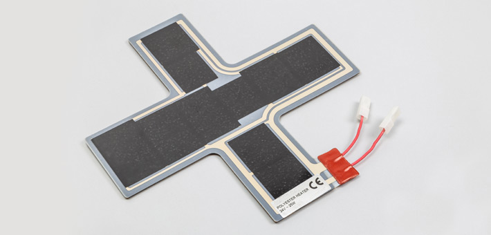 Polyester film heater with termination adjacent to the heating surface